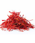 Red dried saffron threads on a white background