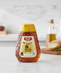 Bottle of Truffle Honey on a kitchen counter with a blurred background