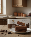 Chocolate cookies on a plate with a box labeled 'Gentilini' in a kitchen setting.