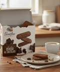 Box of Gentilini cookies with a cup of coffee on a wooden table