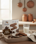 Box of Gentilini cookies with a plate of cookies and a glass of milk on a wooden tray.