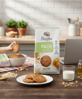 Gentilini Piaceri cookies on a plate with packaging, bowl of cookies, and laptop in a kitchen setting.