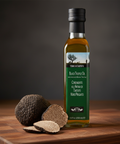 Bottle of black truffle oil with truffles on a wooden surface