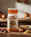 Bag of chestnut flour with chestnuts and a bowl on a wooden surface