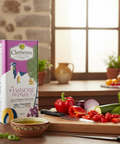 Clemente olive oil box on a kitchen counter with vegetables and a bowl of oil.