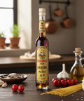 Bottle of Yálo Rizzoli Colatura d'Alici on a wooden table with ingredients in a kitchen setting