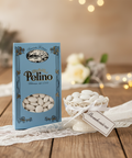 Pelino chocolate box with white candies on a wooden table with decorative elements