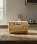 Block of Ferrarini butter on a wooden table in a kitchen setting