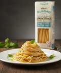 Spaghetti on a plate with a box of Rummo gluten-free spaghetti in the background