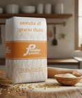 Bag of 'semola di grano duro' flour from Molino Pasini on a wooden table with a kitchen background.