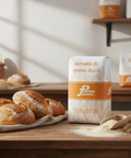 Bag of 'semola di grano dura' flour with bread and flour on a wooden table