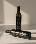 Two bottles of olive oil with labels on a light background