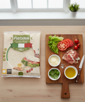 Piadina Italian bread package on a wooden table with ingredients for a sandwich.