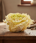 Head of cabbage on a wooden table with a blurred background