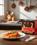 Pasta dish with a box of Rigatoni di Gragnano pasta in a kitchen setting