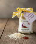 Jar of rice with saffron and a decorative tag on a wooden surface