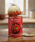 Can of Rosso Gargano chopped tomatoes on a wooden surface with a kitchen background.