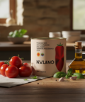 Nulano tomato can with fresh tomatoes, oil, and herbs on a wooden table.