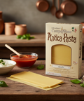 Box of Antica Pasta with pasta sheets and ingredients on a wooden table