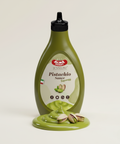 Pistachio sauce bottle with label on a light beige background