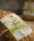 Packaged bread with a label on a wooden surface
