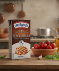 Box of Sterilgarda Besciamella on a kitchen counter with tomatoes and oil