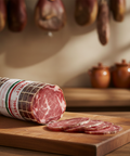 Sliced salami on a wooden cutting board with a blurred background