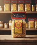 Packaged pasta with Gragnano branding on a wooden surface with shelves in the background.