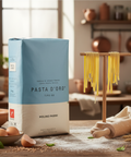 Pasta d'Oro packaging on a kitchen counter with pasta hanging above